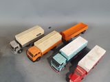 several toy trucks are lined up in a row on a table
