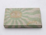 an old green and white box with a picture of a lion on it