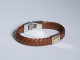 a brown leather bracelet with a silver clasp on a white background
