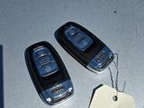 two car keys and a price tag sitting on a table