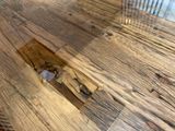 a close up of a wooden table with a comb on it