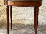 a small table with a glass top on a brick floor