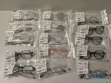 a lot of glasses that are in bags on the table