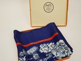 an image of a blue and white floral pocket square in a box
