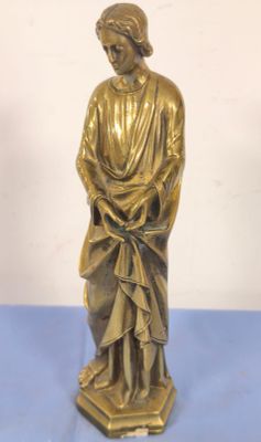 bronze statue of a woman holding a basket on a blue table