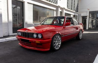 a red car that is parked in front of a building