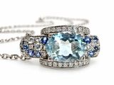a close up of a necklace with a blue topaz and blue sapphires