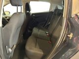 the back seat of a car with the door open and the passenger seat down