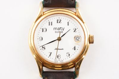 a close up of a gold wrist watch on a white surface