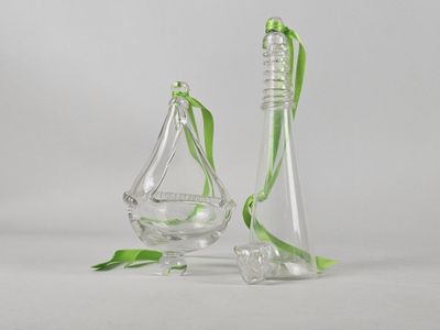 two clear glass vases with green ribbons and a green ribbon
