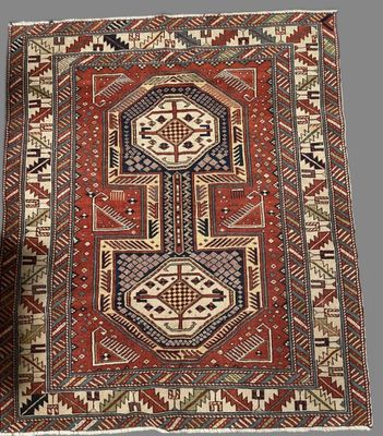 a red and blue rug with a geometric design on it