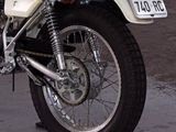 a motorcycle parked in a parking lot with a license plate on it