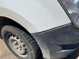 a close up of a white truck with a flat tire