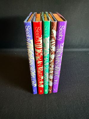 trois livres sont empilés les uns sur les autres sur une surface noire