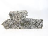 a stone object that is sitting on a white surface