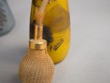 a vase with a flower in it sitting next to a vase with a flower in it