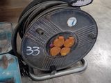 a reel that is sitting on the ground next to a box