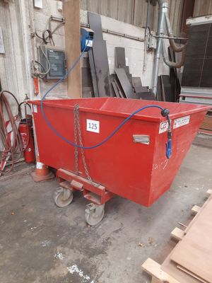 a red dumpster that is sitting in the garage