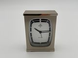 a small clock that is sitting on a table