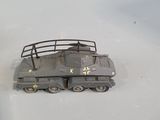 a toy tank that is sitting on a white surface