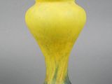 a yellow vase that is sitting on a table