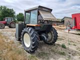 a tractor that is parked in the dirt