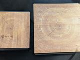 two pieces of wood sitting on top of a table