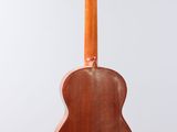 a close up of an acoustic guitar hanging from a string
