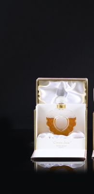 packaging for a perfume bottle in a gold and white box on a black background