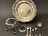 a lot of silverware on a table with spoons and forks