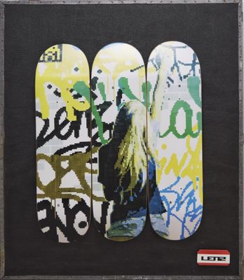 three skateboards that are painted with graffiti on them