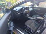 the interior of a car with the door open showing the steering wheel and dashboard