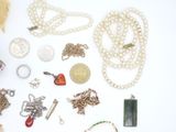 many different types of jewelry on a white surface