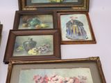 four framed pictures of flowers and fruit on the table