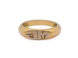 a close up of a gold ring with a small initials on it