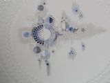 a white plate with a blue and white design on it