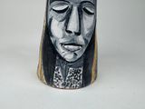 a black and white picture of a woman ' s face on a vase