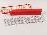 a red box with silverware in it on a white surface