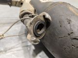 a close up of a motorcycle exhaust pipe with a hose attached to it