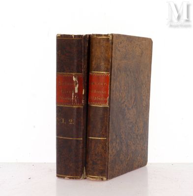 an old book sitting on top of a white table next to a white wall