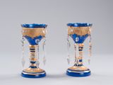 pair of blue and gold glass vases with crystals on them