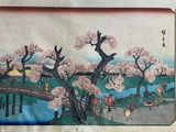 japanese woodblock painting of cherry blossoms on a bridge over a river