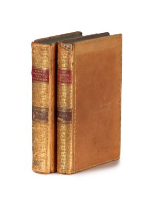 deux vieux livres posés l'un sur l'autre sur une surface blanche