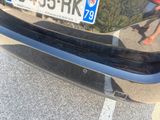 a car with a license plate on it parked in a parking lot
