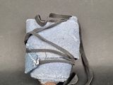 a bag with a strap wrapped around it sitting on a table