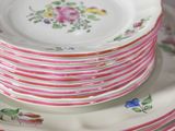 many plates stacked on top of each other on a table