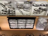 many pairs of glasses sitting on a shelf in a store