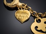 a close up of a gold keychai with a heart shaped charm