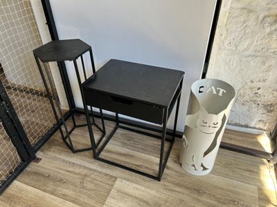 a black table and two stools in a room