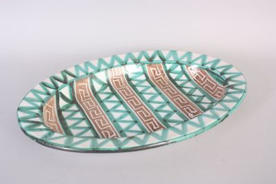 a green and white plate with a design on it